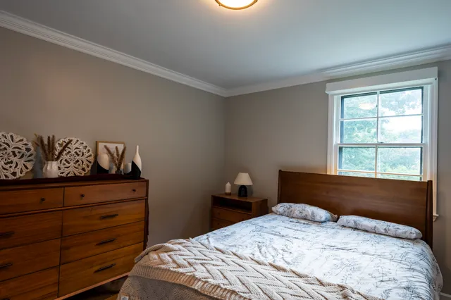 a bedroom with a bed and window