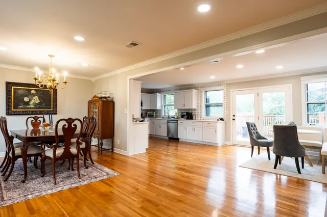 a view of a dining room with furniture and wooden floor