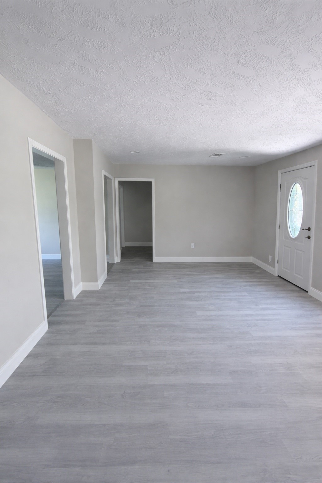 8115 Redfern Drive Houston, TX 77033 - Photo 3 of 7 a view of an empty room with wooden floor