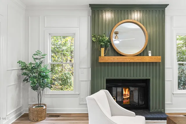 a living room with a fireplace a potted plant and a fireplace