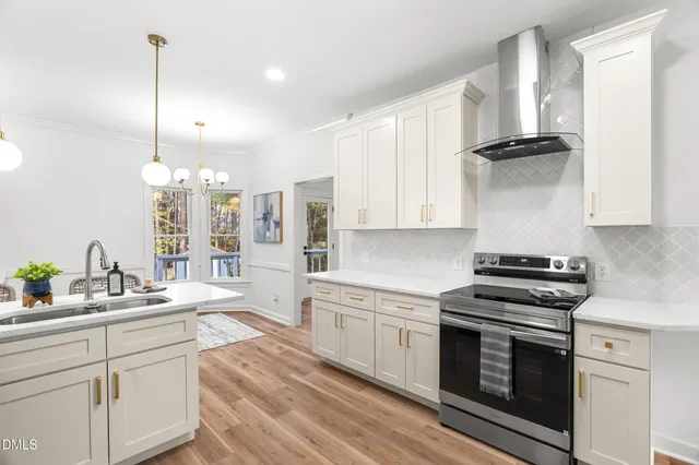 a kitchen with a stove a sink and a refrigerator