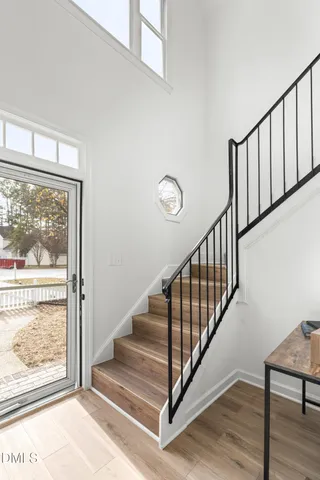 a view of a hallway with wooden floor and a floor to ceiling window