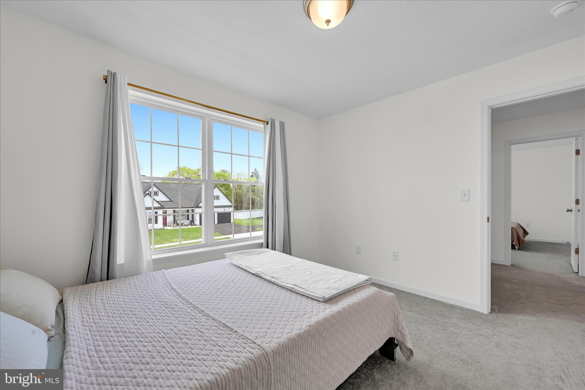 2625 Village Road Dover, PA 17315 - Photo 8 of 15 a bedroom with a bed and a large window