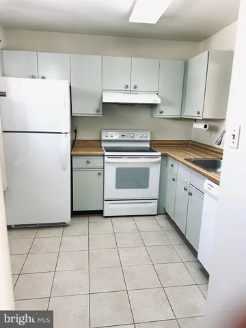 a kitchen with cabinets and appliances