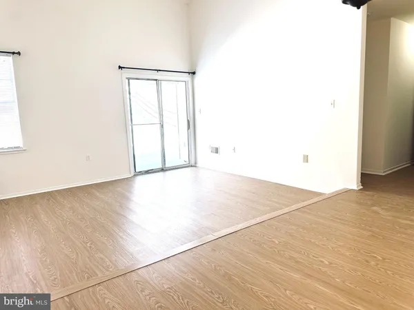 an empty room with wooden floor