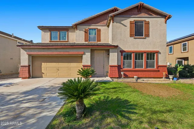 a front view of a house with a yard and garage