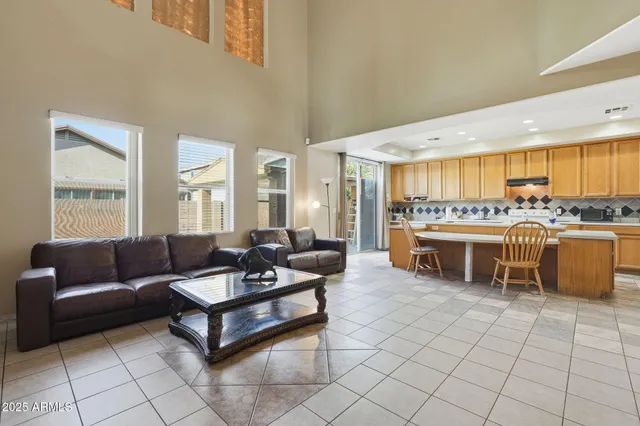 a living room with furniture and kitchen view