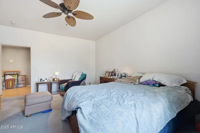 a bedroom with bed and a chandelier
