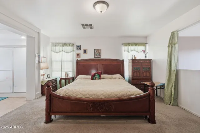 a bedroom with a bed and window