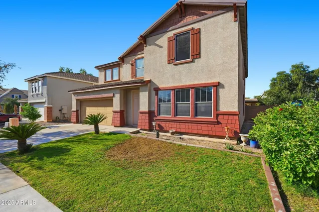 a view of a house with a yard and sitting area