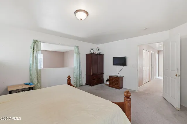 a bedroom with bed and window