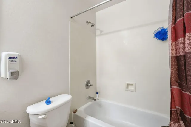 a white bath tub sitting next to a white toilet