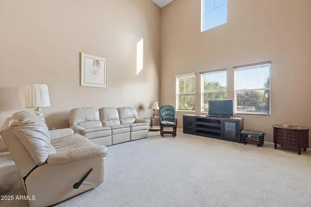 a living room with furniture and a floor to ceiling window