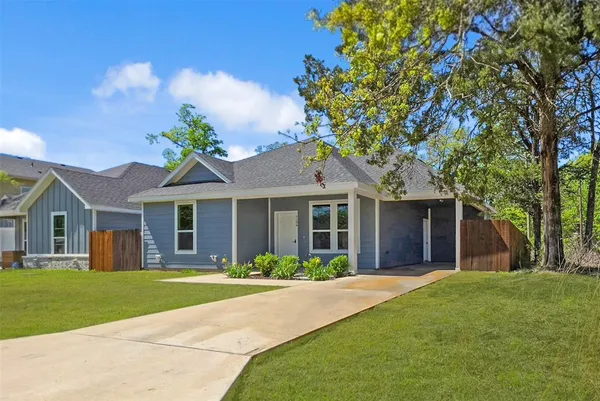 a front view of house with yard and green space