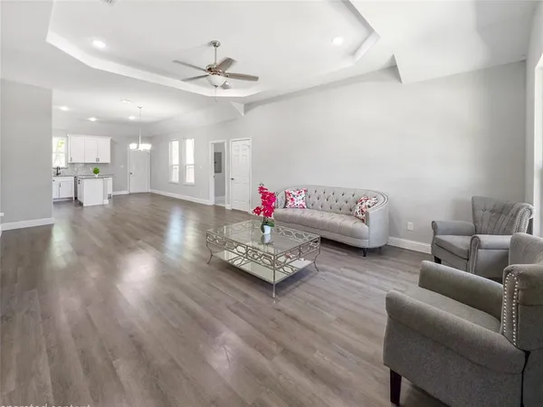 a living room with furniture and wooden floor