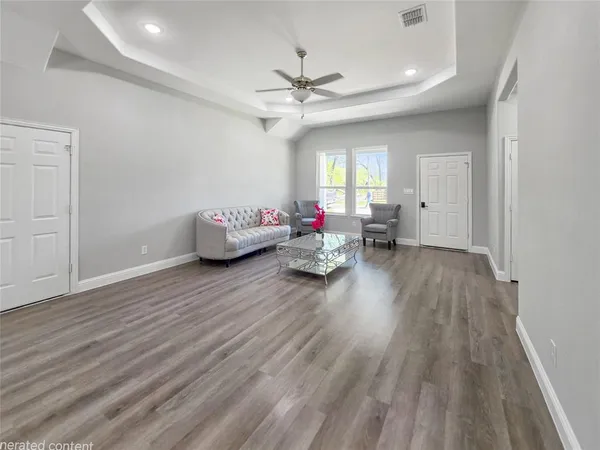 a living room with furniture and wooden floor