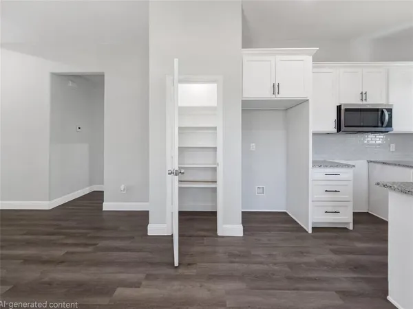 a view of kitchen with wooden floor and electronic appliances