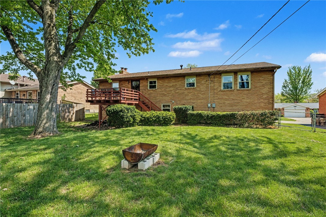 4919 Silver Arrow Drive Riverside, OH 45424 - Photo 52 of 57 This residence boasts a vibrant green yard with a spacious deck, perfect for outdoor enjoyment.