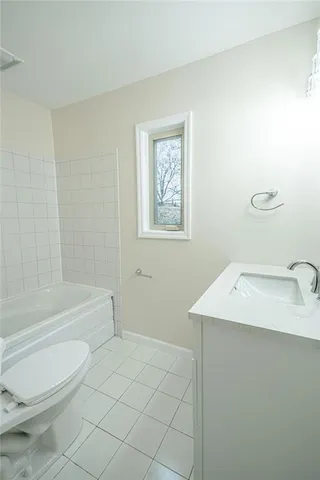 a bathroom with a sink a toilet and bathtub