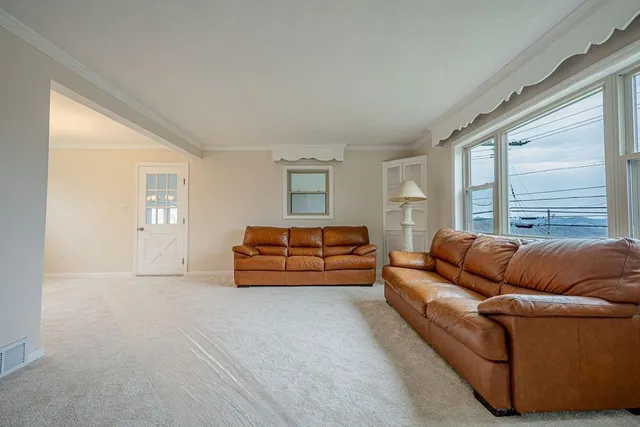 a bedroom with furniture and a large window