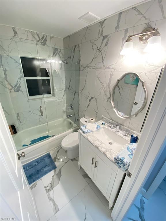 1221 Granada Boulevard Naples, FL 34103 - Photo 11 of 16 a bathroom with a sink a toilet and shower