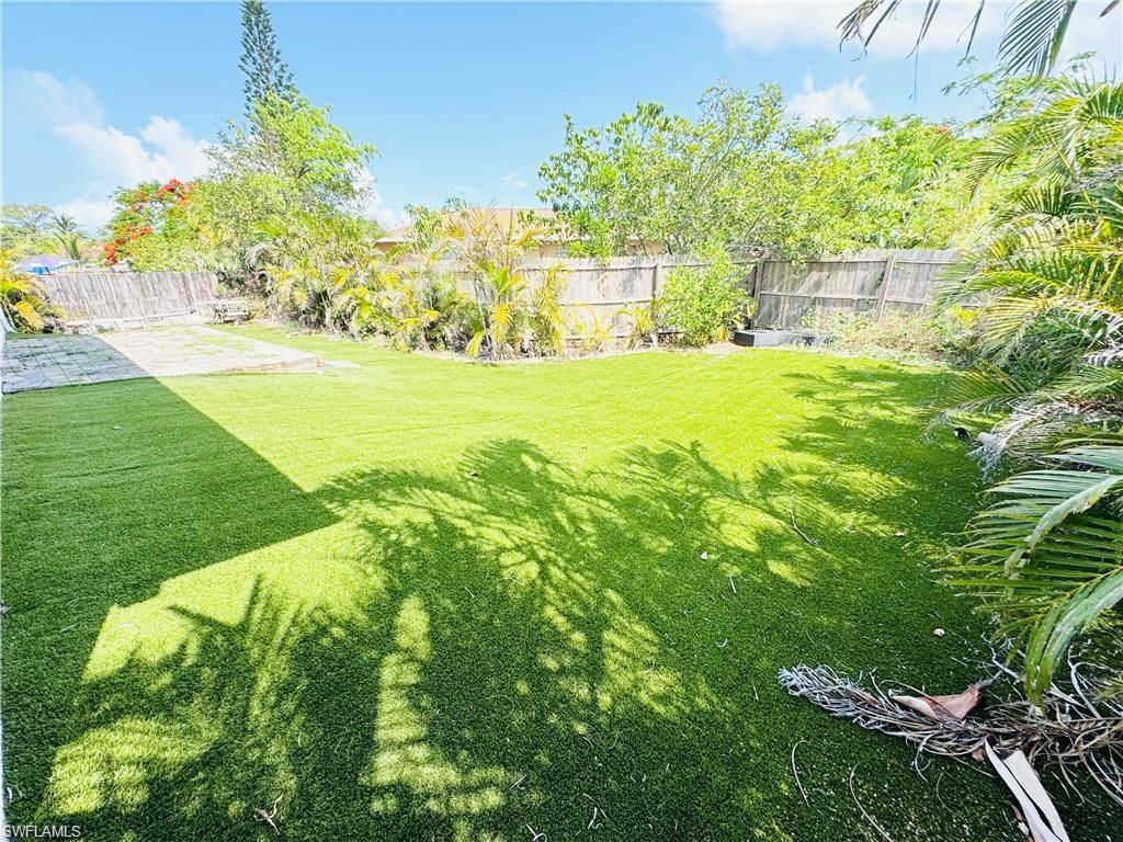 1221 Granada Boulevard Naples, FL 34103 - Photo 15 of 16 a garden with trees in the background