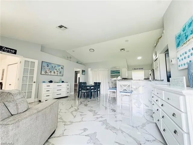 a large white kitchen with cabinets