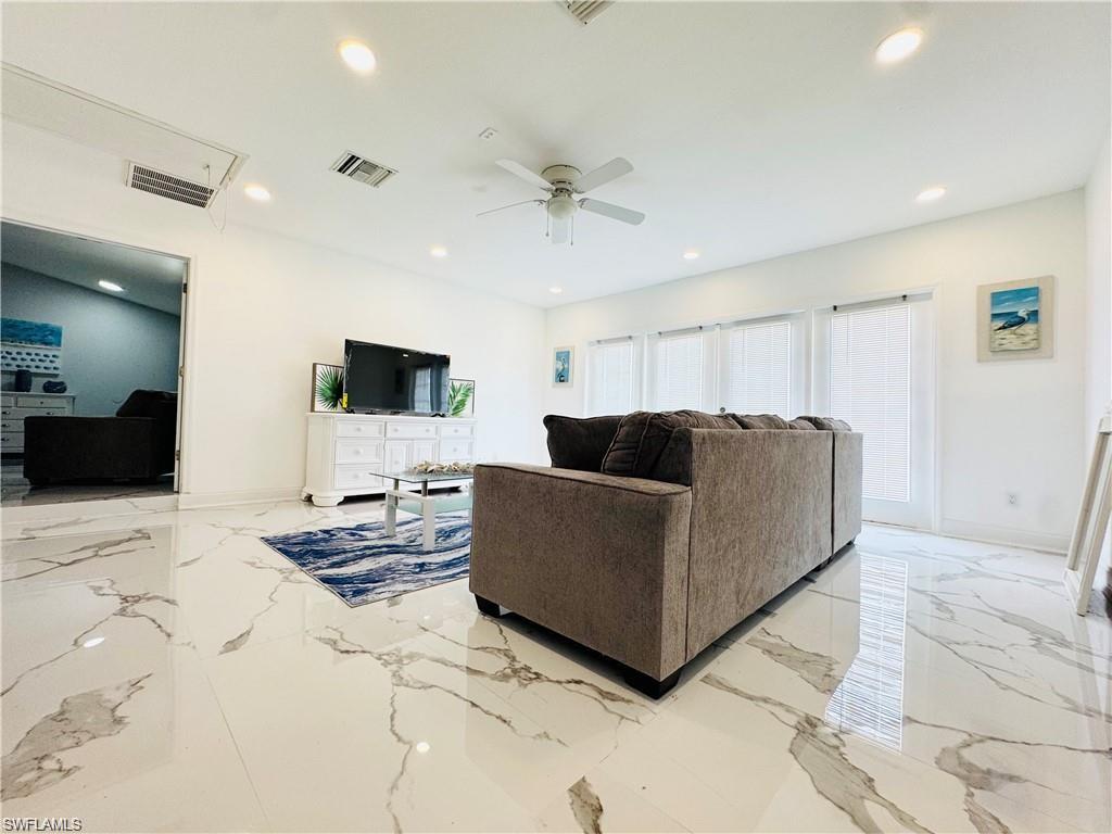 1221 Granada Boulevard Naples, FL 34103 - Photo 7 of 16 a living room with furniture and a flat screen tv