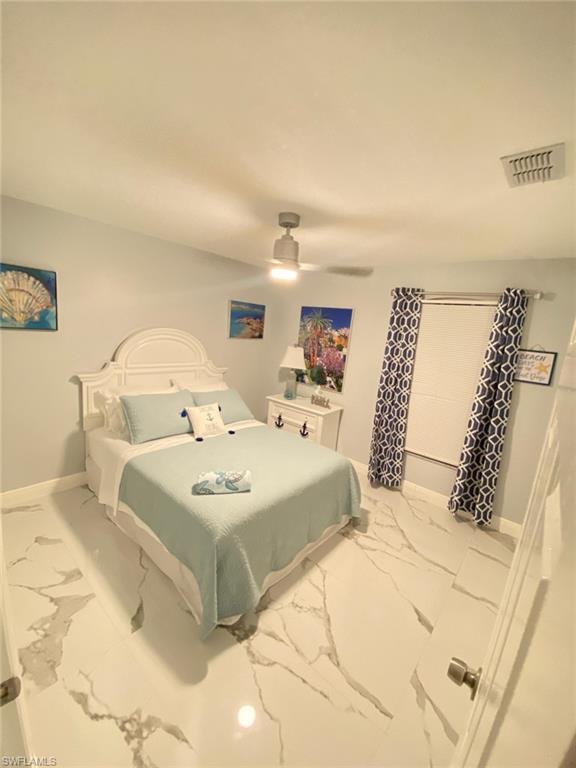 1221 Granada Boulevard Naples, FL 34103 - Photo 10 of 16 a bedroom with a large bed and a couch