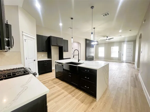 a kitchen with a refrigerator and a sink