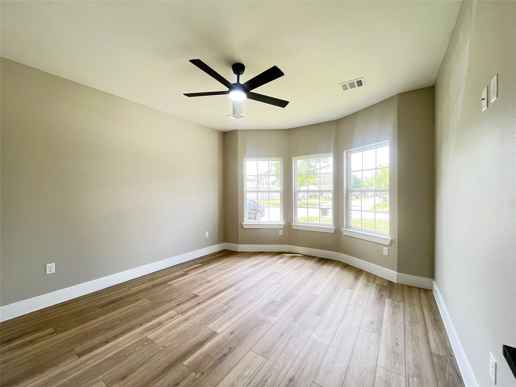 8914 Ivy Spring Lane Houston, TX 77088 - Photo 15 of 33 a view of an empty room with wooden floor and a window