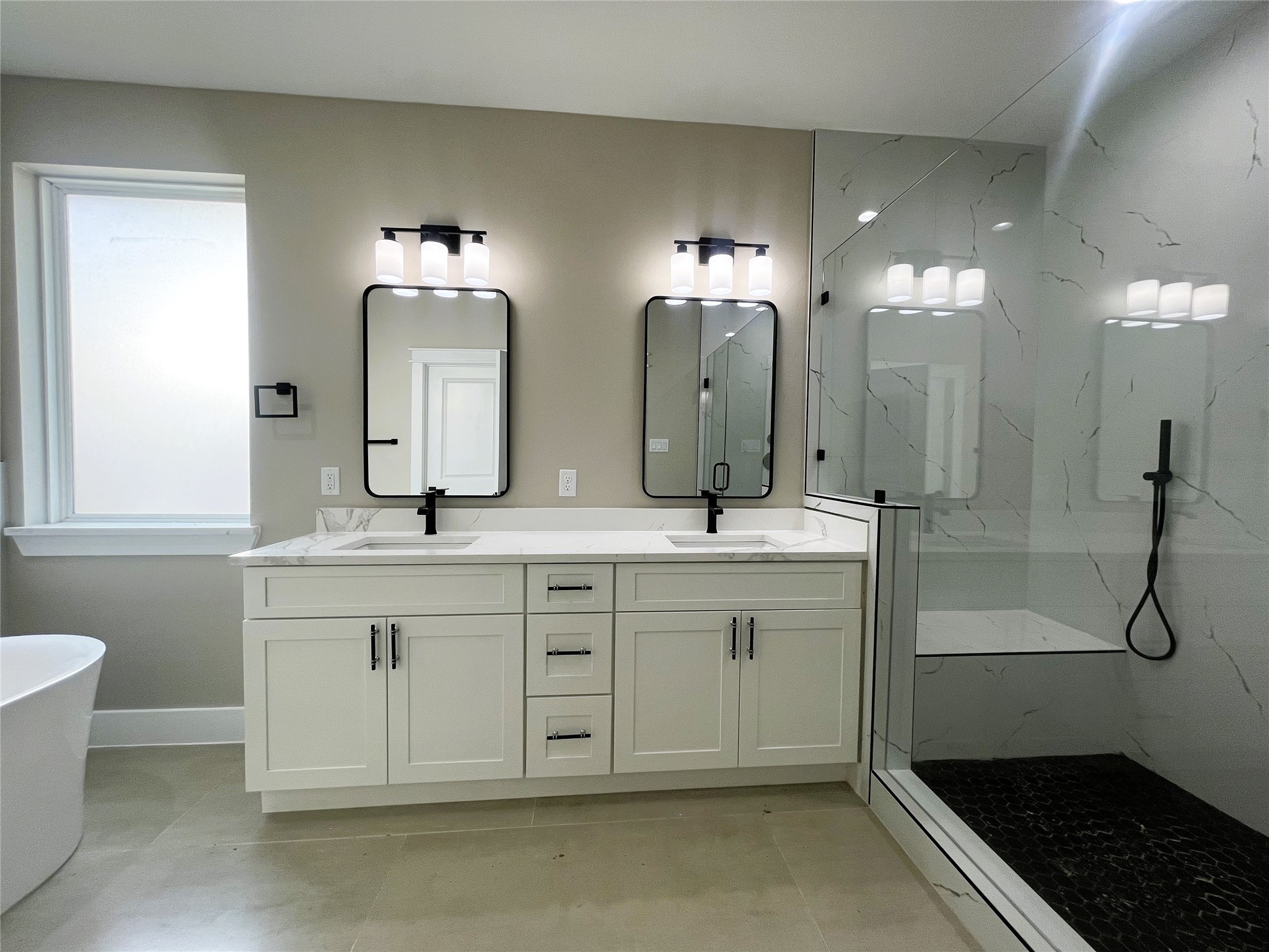 8914 Ivy Spring Lane Houston, TX 77088 - Photo 18 of 33 a spacious bathroom with a double vanity sink a mirror and a shower