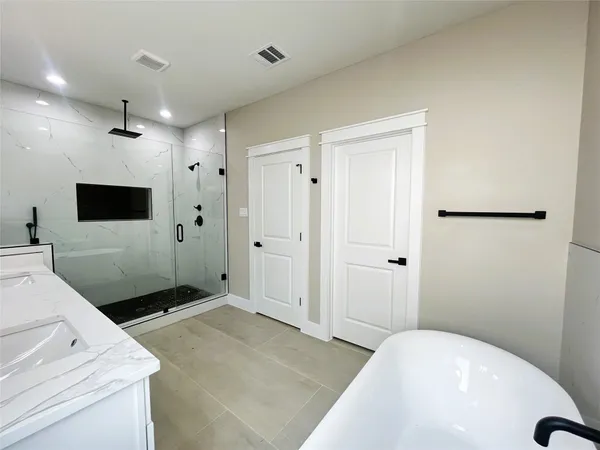 a spacious bathroom with a sink and a large mirror