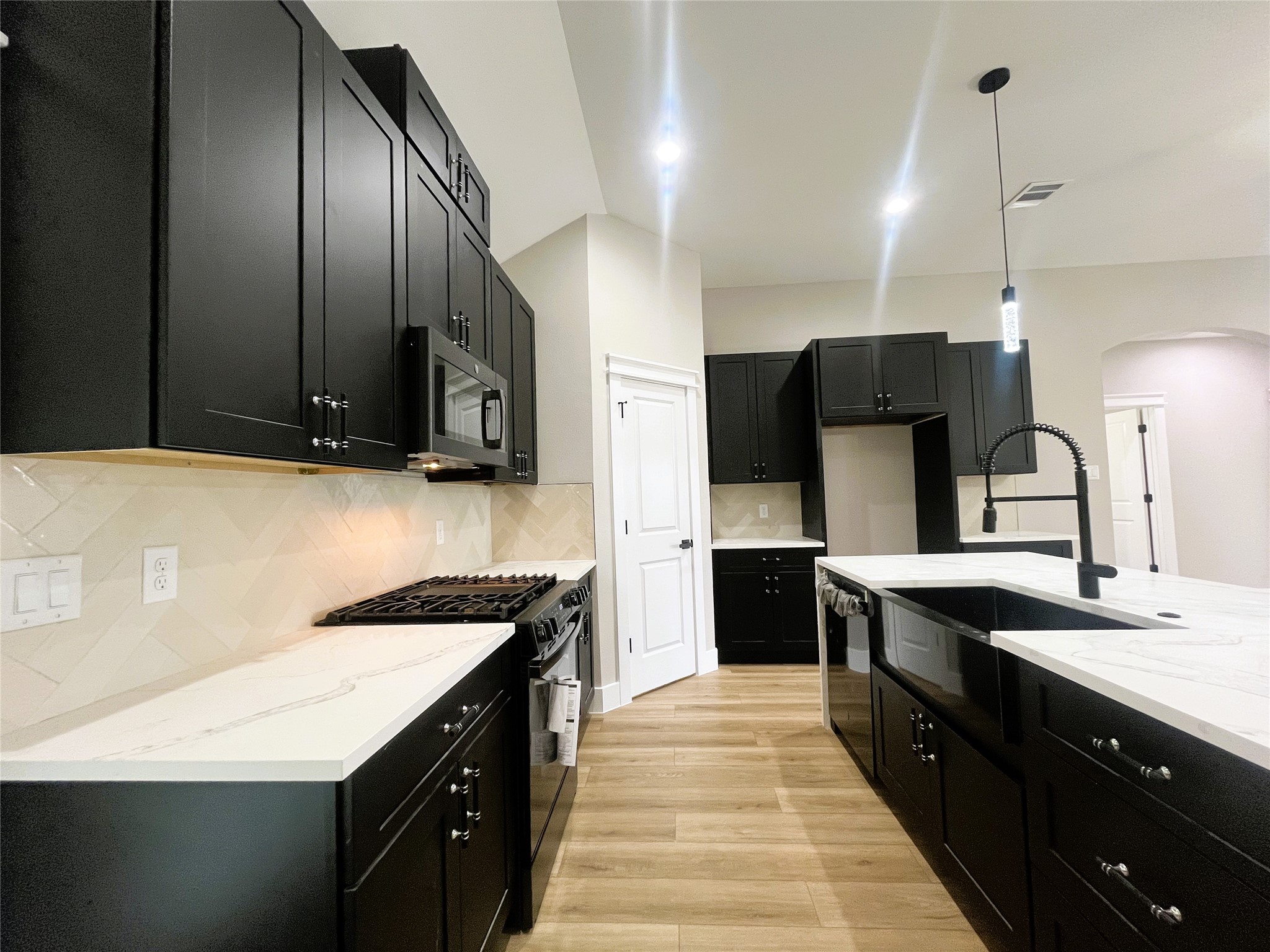 8914 Ivy Spring Lane Houston, TX 77088 - Photo 10 of 33 a kitchen with stainless steel appliances granite countertop a sink a stove and a refrigerator