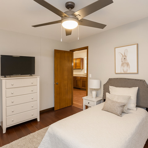 406 South Jackson Street Gardner, IL 60424 - Photo 11 of 13 a bedroom with a bed and a flat tv screen on dresser