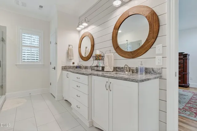 a white bath tub sitting in a bathroom next to a window
