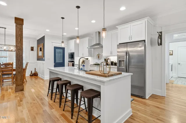 a kitchen with stainless steel appliances granite countertop a sink and a refrigerator