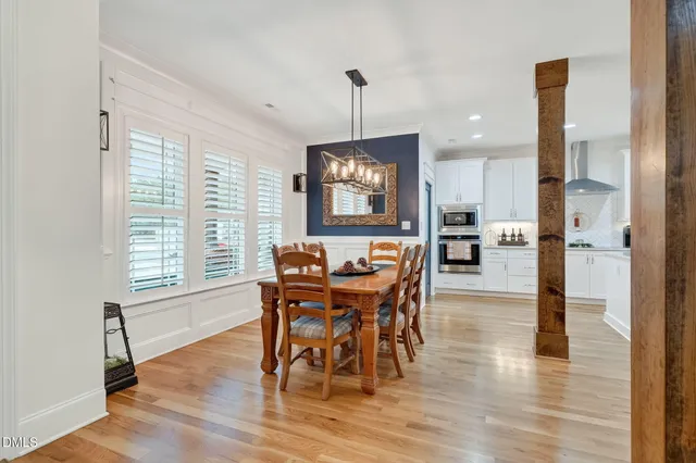 a living room with furniture chandelier and a large window