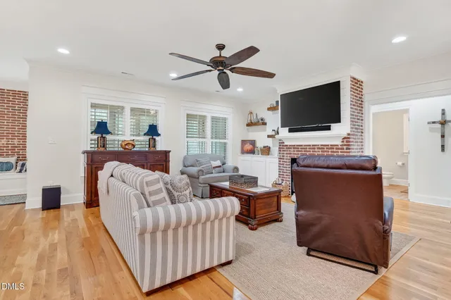 a dining room with furniture a chandelier and wooden floor