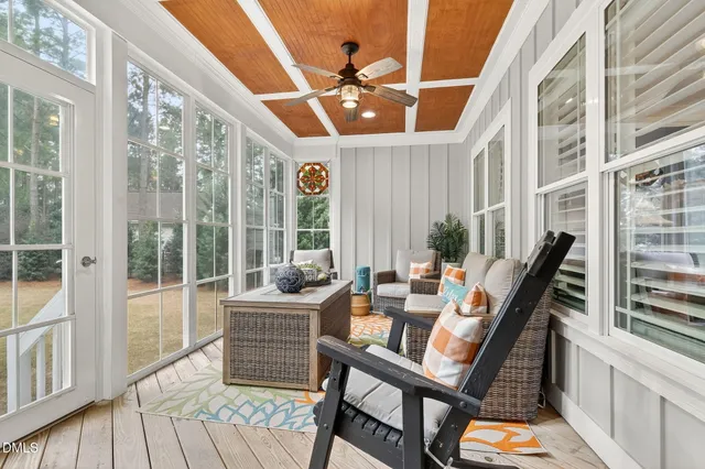 a bedroom with a bed couch and a chandelier