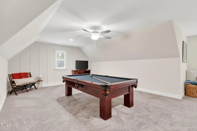 a room with furniture pool table and window
