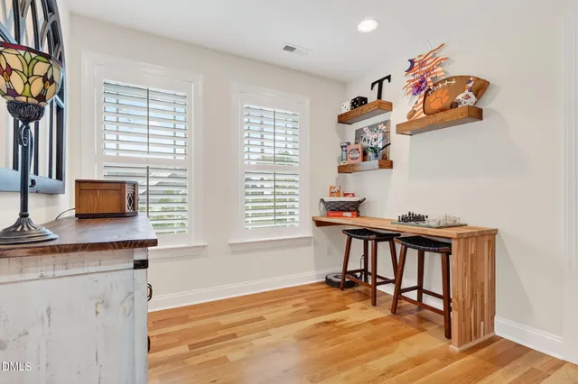 a backyard of a house with barbeque oven table and chairs