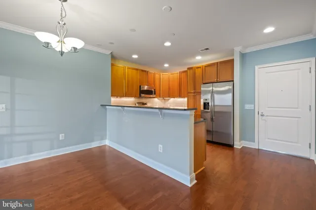 a kitchen with stainless steel appliances granite countertop a refrigerator and a sink