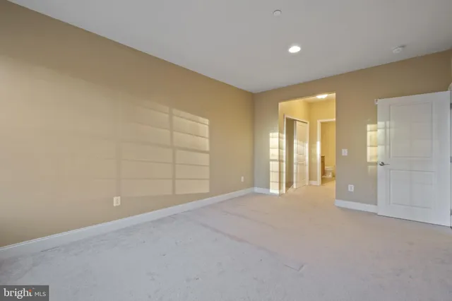 a bathroom with a granite countertop sink a toilet and a large mirror