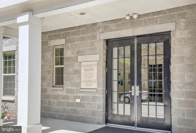a front view of a house with a yard and fountain