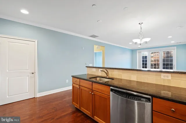 a kitchen with granite countertop a sink and a window