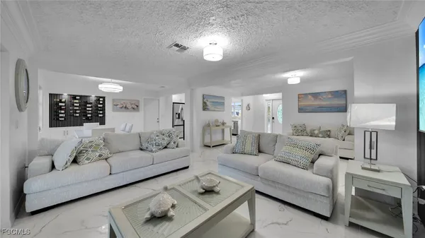 a living room with furniture and a lamp