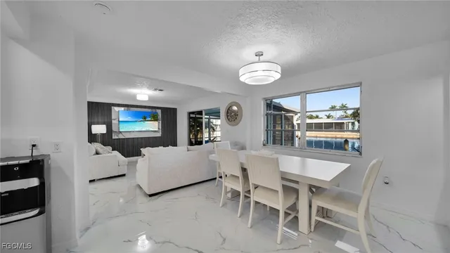 a view of a dining room with furniture and chandelier