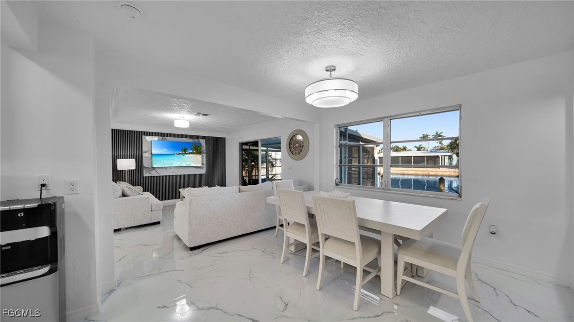 2758 Bruce Street Matlacha, FL 33993 - Photo 12 of 35 a view of a dining room with furniture and chandelier