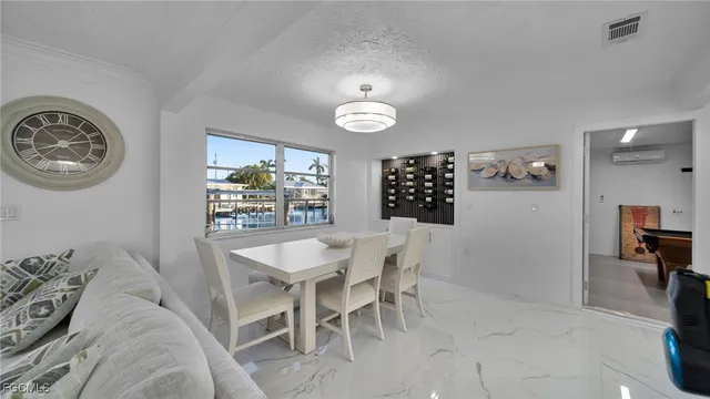a view of a dining room with furniture and chandelier